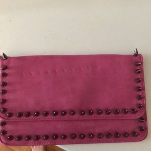 Pink clutch with gunmetal spikes